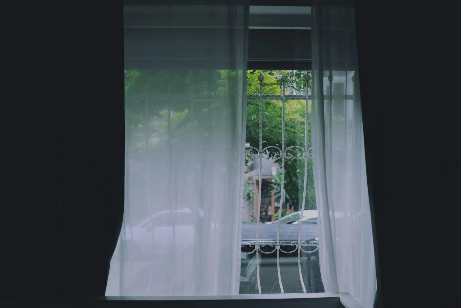 Layered blinds and curtains in a living room